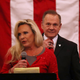Roy Moore stands behind his wife Kayla Moore as she speaks during a campaign event at Jordan’s Activity Barn on December 11, 2017 in Midland City, Alabama.